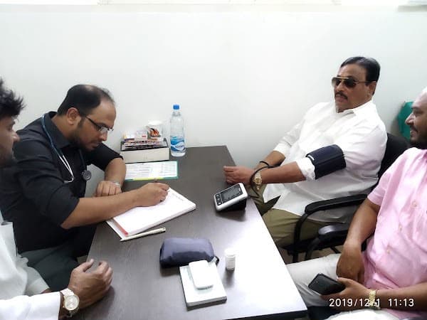 Dr. Adnan Aziz in consultation with a patient